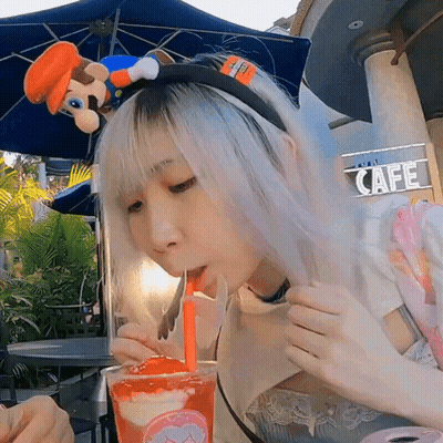 Girl With Mario Headband Drinking From Straw GIF