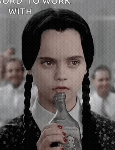 Girl With Pigtails Holding Liquor Bottle In Mouth GIF