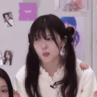 Girl With Pigtails Sitting With Microphone GIF