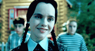 Girl With Pigtails Smiling In Front Of Children GIF