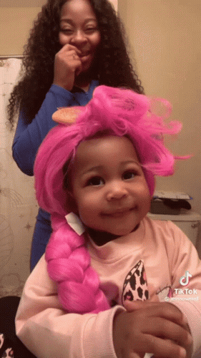 Girl With Pink Braided Wig Being Brushed GIF