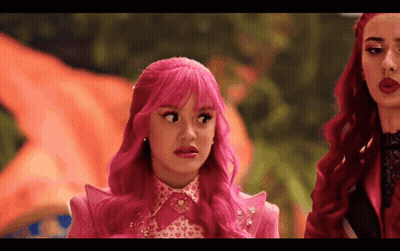 Girl With Pink Hair Making Funny Face Next To Redhead GIF