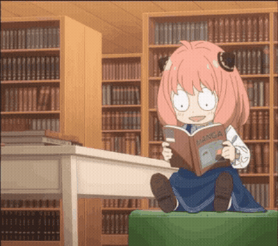 Girl With Pink Hair Reading Manga In Library GIF