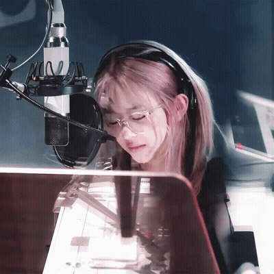 Girl With Pink Hair Wearing Headphones And Glasses At Microphone GIF