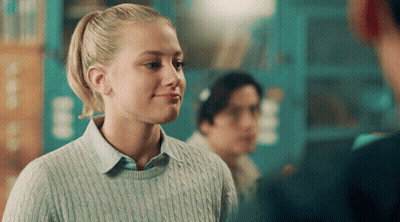 Girl With Ponytail In Blue Sweater Smiling GIF