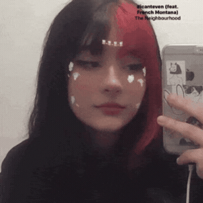 Girl With Red And Black Hair Taking Selfie In Mirror GIF