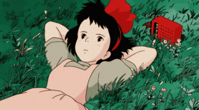 Girl With Red Bow Laying In Grass GIF