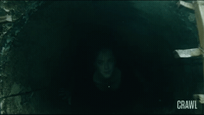 Girl With Red Hair And Black Tie In Dark Hallway GIF