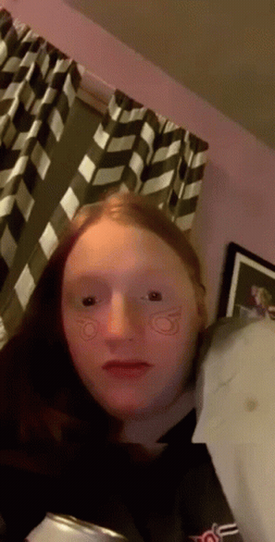 Girl With Red Hair Sitting By Window GIF