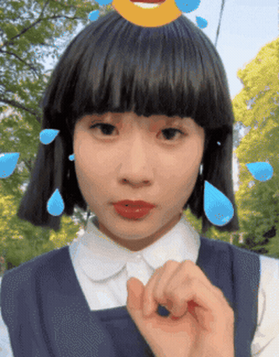 Girl with Smiley Face on Head Making Hand Gesture