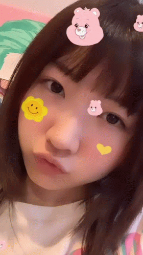 Girl With Stickers on Face Including Pink Bear