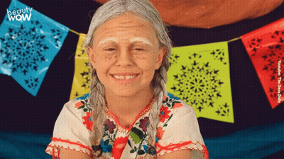 Girl With White Paint Smiling In Front Of Beauty Wow Banner GIF