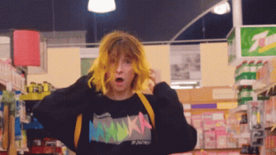Girl With Yellow Hair In Black Sweater Saying Nikka GIF