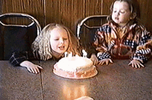 Girls Blowing Birthday Candles On Cake GIF