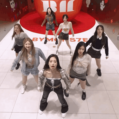 Girls Dancing In Front Of By Monster Sign GIF