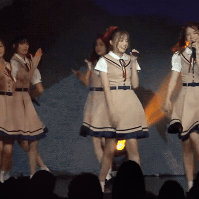 Girls In School Uniforms Singing Into Microphones GIF