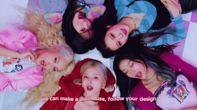 Girls Laying In Circle With Dollhouse Design GIF