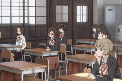 Girls Sitting At Desks In Classroom GIF