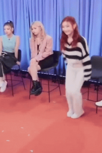 Girls Sitting In Chairs On Red Carpet GIF