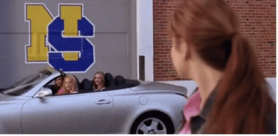 Girls Sitting In Silver Convertible Car In Front Of Building With Letter S GIF