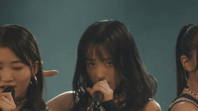 Girls Standing On Stage With Fists In Air GIF