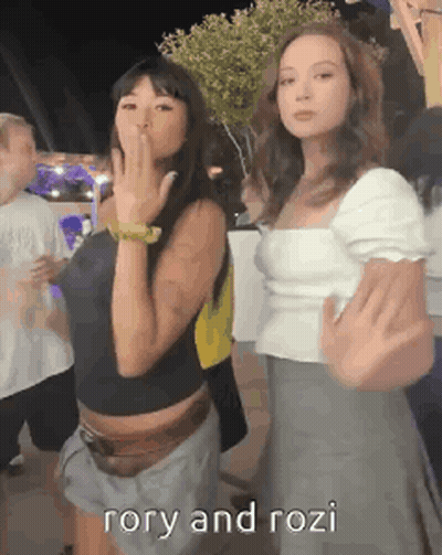 Girls Standing Together One Pointing GIF