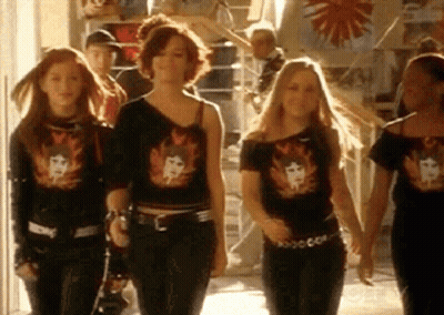 Girls Walking Down Hallway In Black Shirts GIF