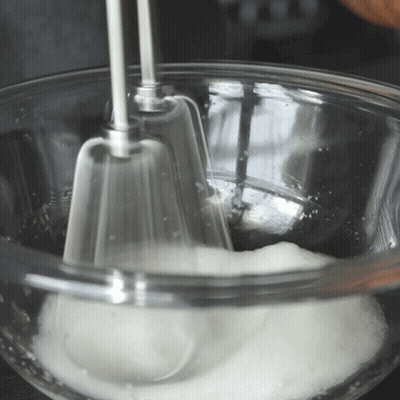 Glass Bowl Of Whipped Cream With Mixer GIF