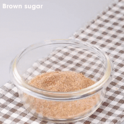 Glass Bowl With Brown Sugar And Peanut Butter And Tongs GIF