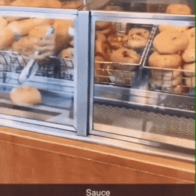 Glass Display Case Filled With Donuts Saying Sauce GIF