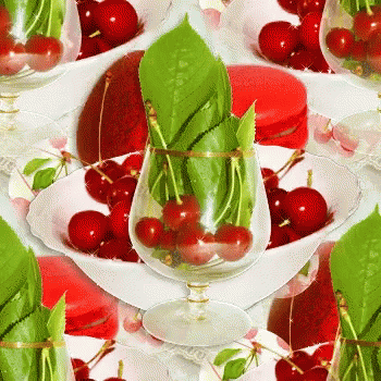 Glass Of Cherries With Green Leaves GIF