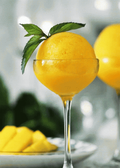 Glass Of Yellow Ice Cream With Mint Leaf GIF