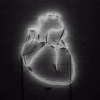Glowing Neon Human Heart On Brick Wall GIF