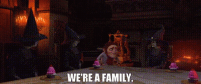 Gnomes Standing Around Table Saying We're A Family GIF