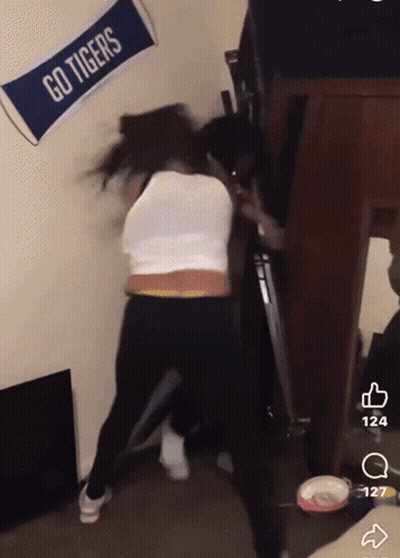 Go Tigers Banner Next To Woman GIF