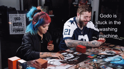 Godo Is Stuck In The Washing Machine With A Man And Woman Playing A Board Game GIF