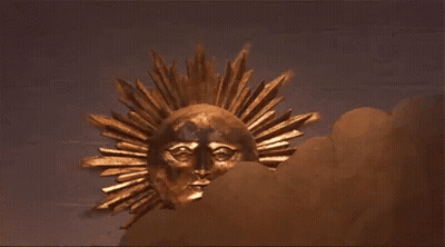 Gold Sun With Face Hanging On Wall GIF