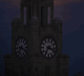 Gold Super Moon Behind Clock Tower GIF
