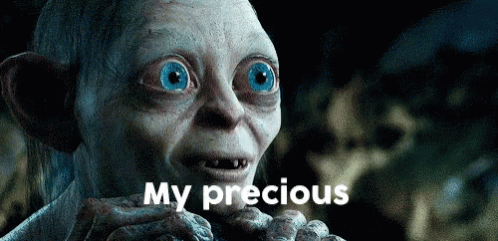 Gollum From The Lord Of The Rings Is Holding Something In His Hand And Says My Precious GIF
