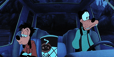 Goofy Is Sitting In The Back Seat Of A Car With A Cup Of Soup GIF