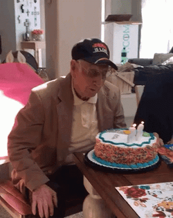 Grandpa Blows Happy 65Th Birthday Cake GIF