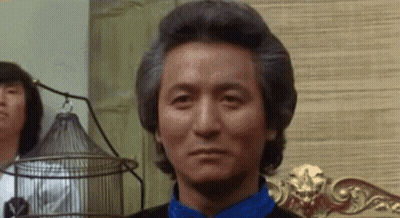 Gray Haired Man In Blue Shirt Sitting On Chair GIF