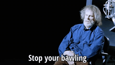 Gray Haired Man In Chair Says Stop Your Bawling GIF