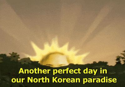 Gray-Haired Man In White Jacket Smiling At Love Yourself Sign GIF