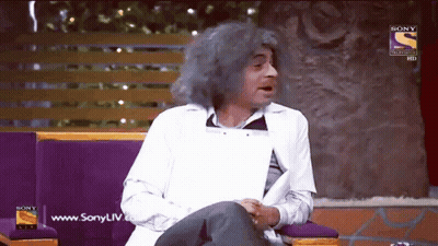 Gray-Haired Man Sitting On Couch With Sony Logo GIF