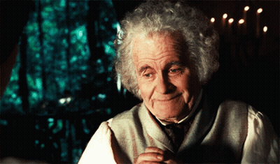 Gray-Haired Man Smiling By Window With Candles GIF