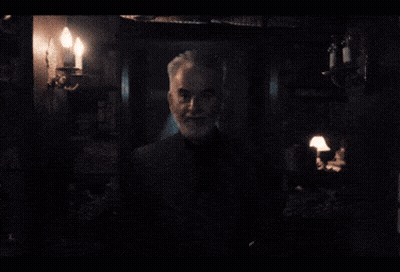 Gray-Haired Man With Beard in Dark Room