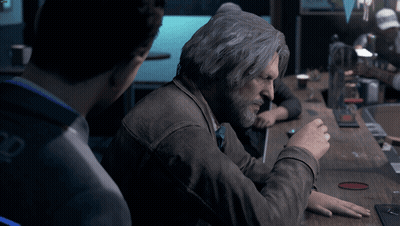 Gray-Haired Man With Beard Sitting At Table GIF