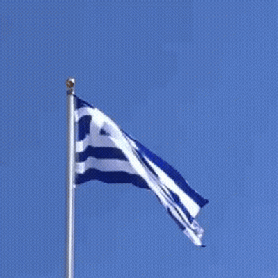 Greek Flag Flying In Wind Against Blue Sky GIF
