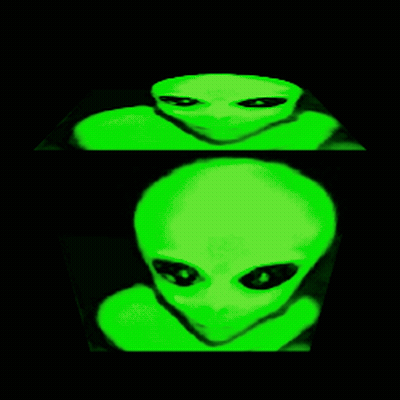 Green Alien With Black Eyes Looking At Camera GIF